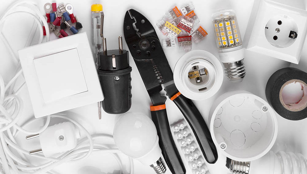 top view of electrical tools and equipment on white